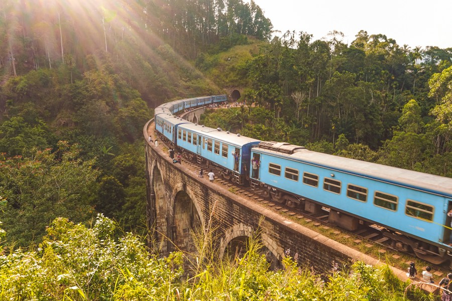 Blue train winding over Ella’s Nine Arch Bridge